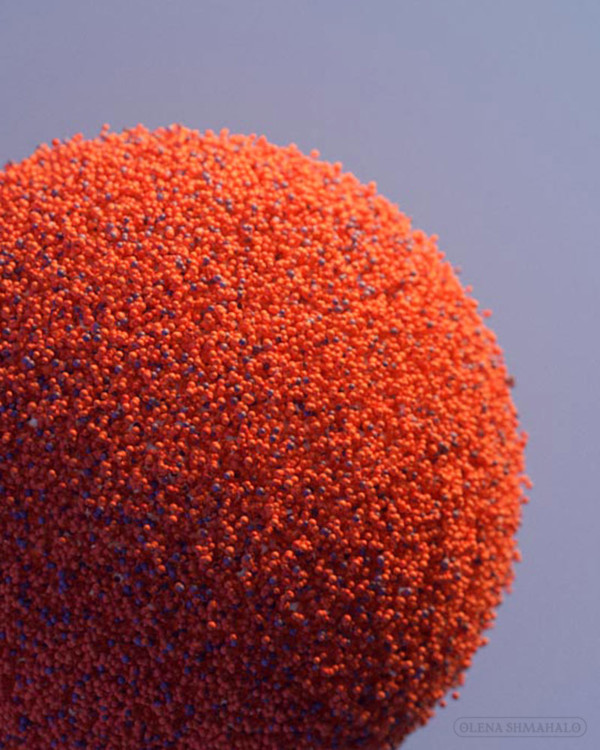 3D art: orange spheres made up of millions of tiny particles.